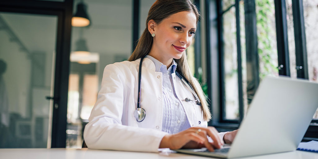 Female doctor working on laptop