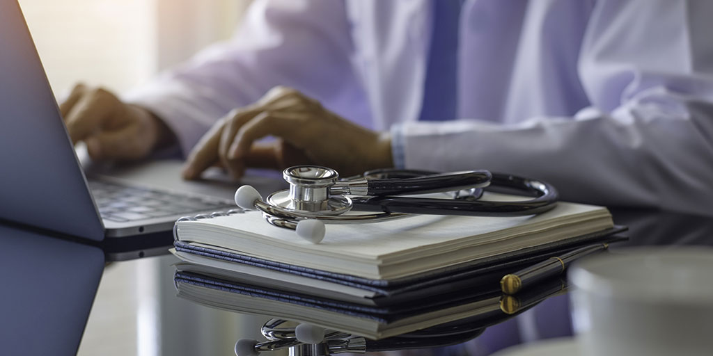 doctor on laptop with stethoscope on notebook