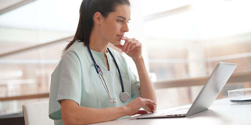 A doctor on her laptop.